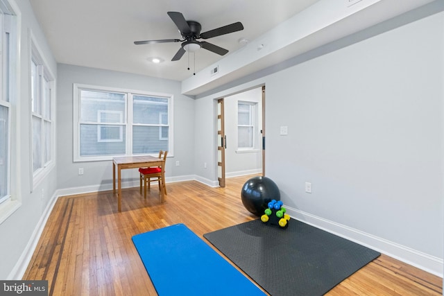 exercise room featuring wood-type flooring and ceiling fan