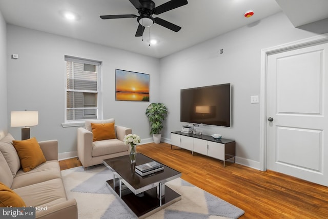 living room featuring ceiling fan and light hardwood / wood-style floors