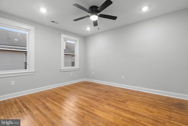 spare room featuring light hardwood / wood-style flooring and ceiling fan