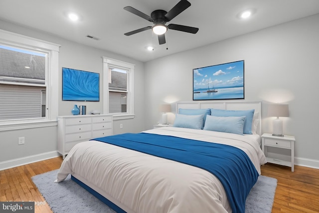 bedroom with wood-type flooring and ceiling fan