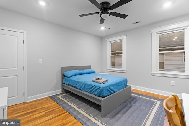 bedroom with light hardwood / wood-style flooring and ceiling fan