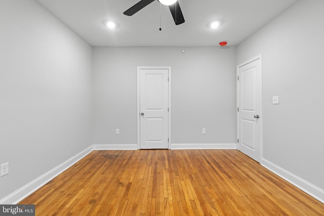 spare room featuring light hardwood / wood-style floors and ceiling fan