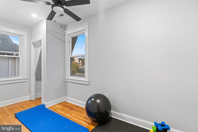 workout area featuring hardwood / wood-style floors, a wealth of natural light, and ceiling fan