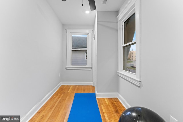 exercise area with hardwood / wood-style flooring and ceiling fan