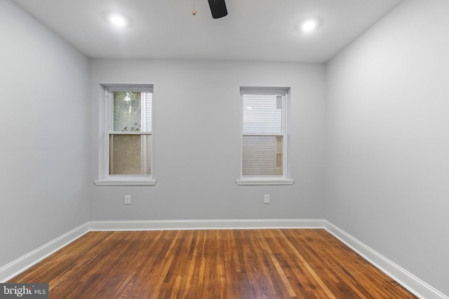 spare room featuring hardwood / wood-style floors and ceiling fan