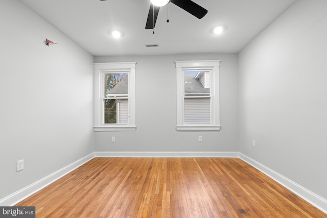 spare room featuring hardwood / wood-style flooring and ceiling fan