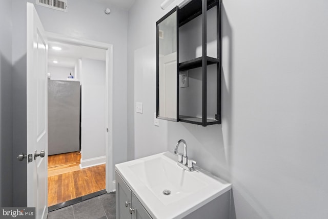 bathroom featuring vanity and hardwood / wood-style floors