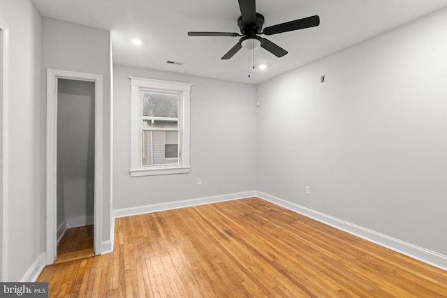 spare room with ceiling fan and light hardwood / wood-style floors