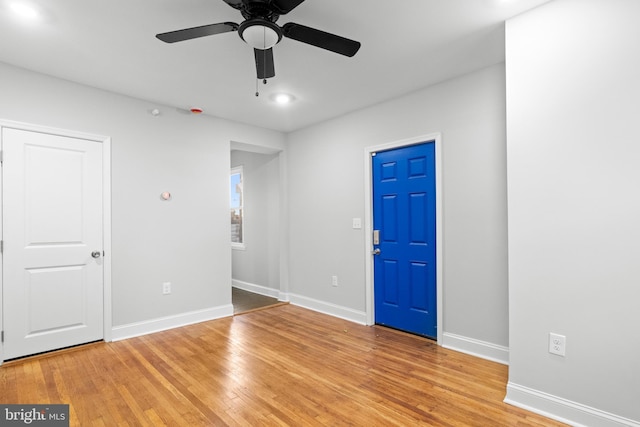 spare room featuring ceiling fan and light hardwood / wood-style floors