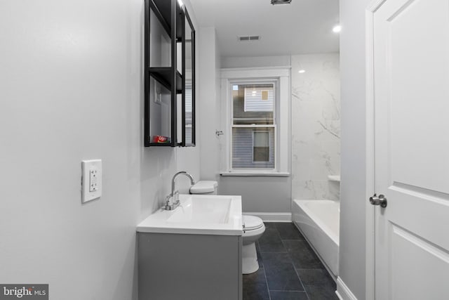 full bathroom featuring toilet, tiled shower / bath combo, vanity, and tile patterned flooring