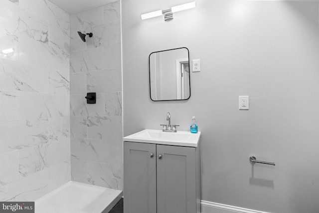 bathroom featuring vanity and a tile shower