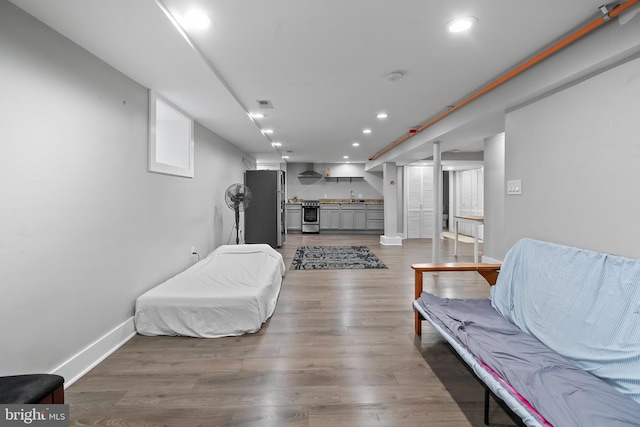 bedroom featuring sink, stainless steel fridge, and dark hardwood / wood-style floors