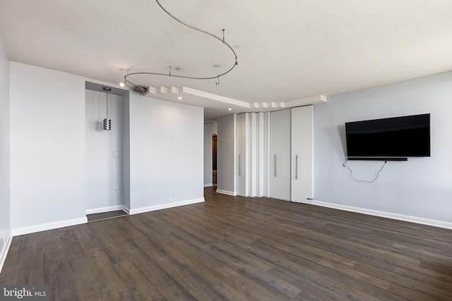 basement with dark hardwood / wood-style floors