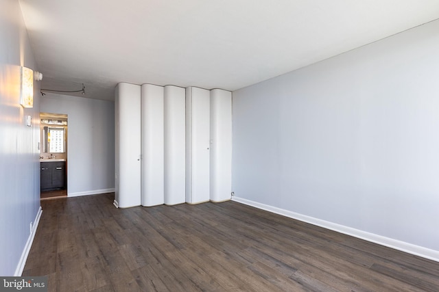 unfurnished room featuring dark wood-type flooring