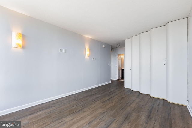 empty room with dark hardwood / wood-style floors