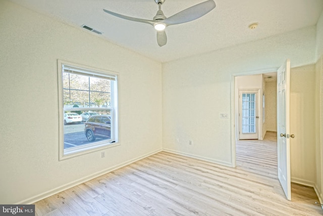 empty room with light wood-type flooring and ceiling fan