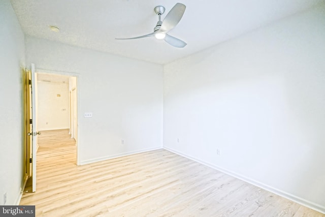 spare room featuring light wood-type flooring and ceiling fan