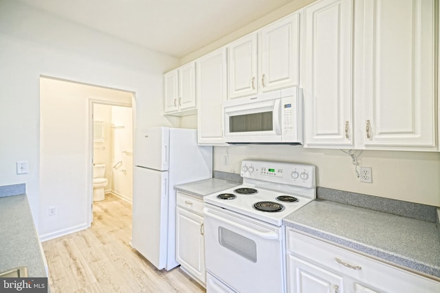 kitchen featuring light wood-type flooring, white appliances, and white cabinets