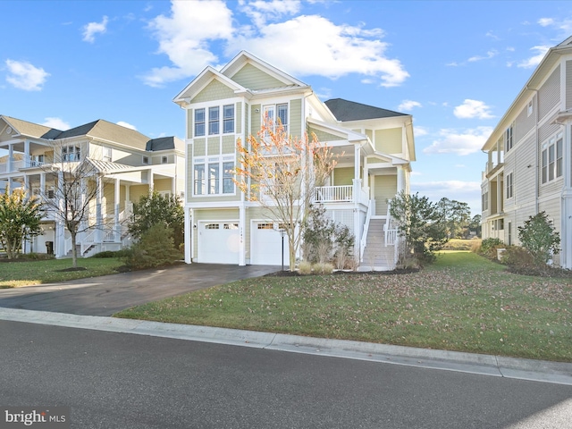 view of front of home with a front lawn, a porch, and a garage