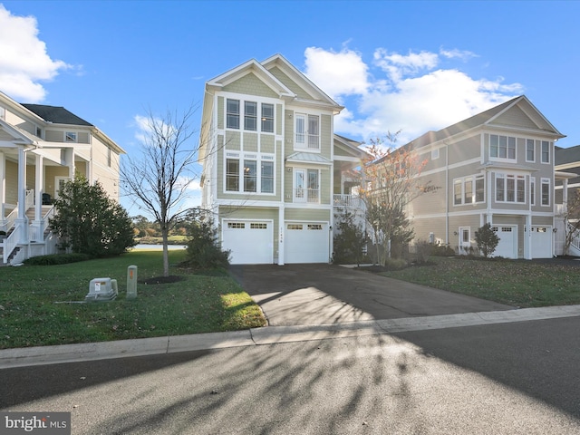 view of front facade with a front yard and a garage