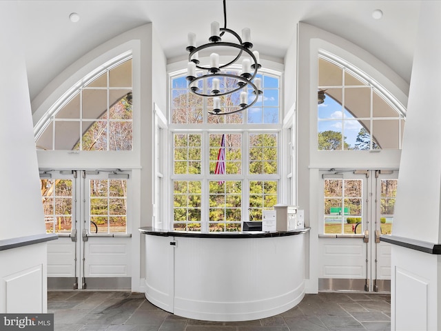 interior space featuring a wealth of natural light and a notable chandelier