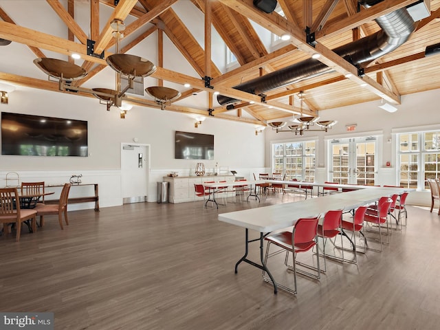 dining area featuring beam ceiling, high vaulted ceiling, dark wood-type flooring, french doors, and wood ceiling