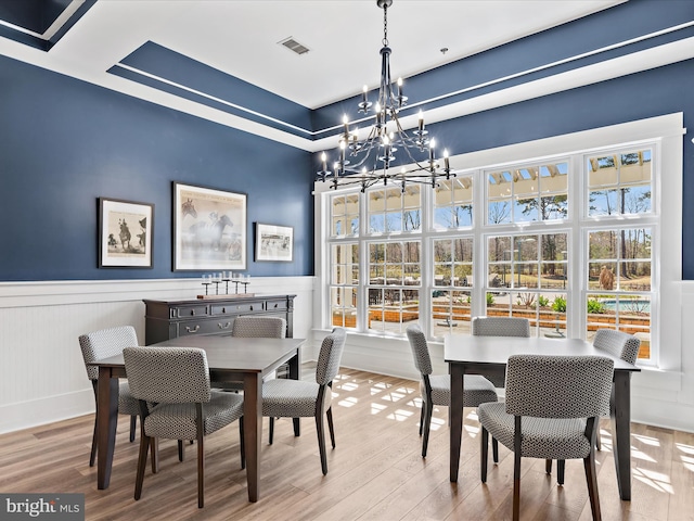 dining area with a chandelier and light hardwood / wood-style floors