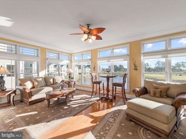 sunroom / solarium featuring ceiling fan