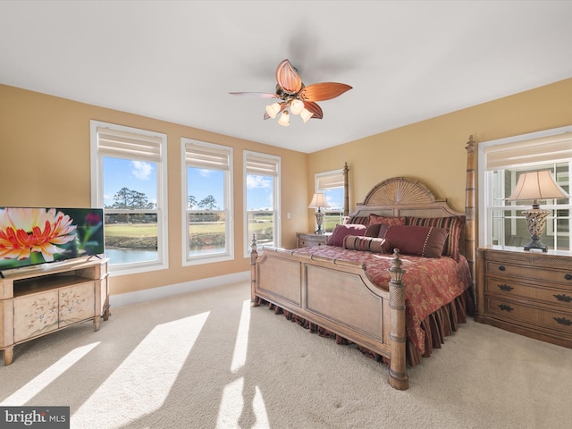 bedroom with ceiling fan and light carpet