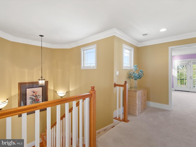 hall with crown molding, carpet flooring, and plenty of natural light