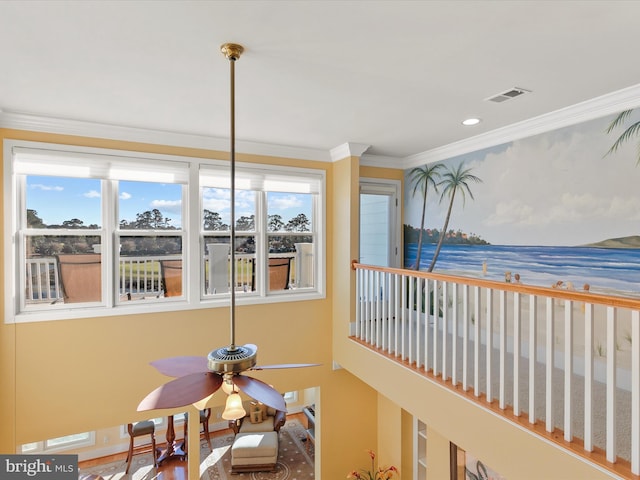 sunroom with ceiling fan, a water view, and a healthy amount of sunlight