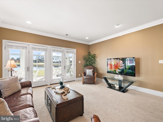 carpeted living room with french doors and crown molding