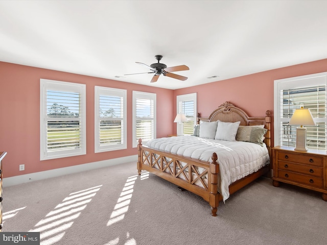 bedroom with ceiling fan and light colored carpet