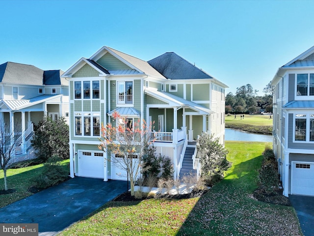 view of front facade featuring a front lawn, covered porch, and a garage