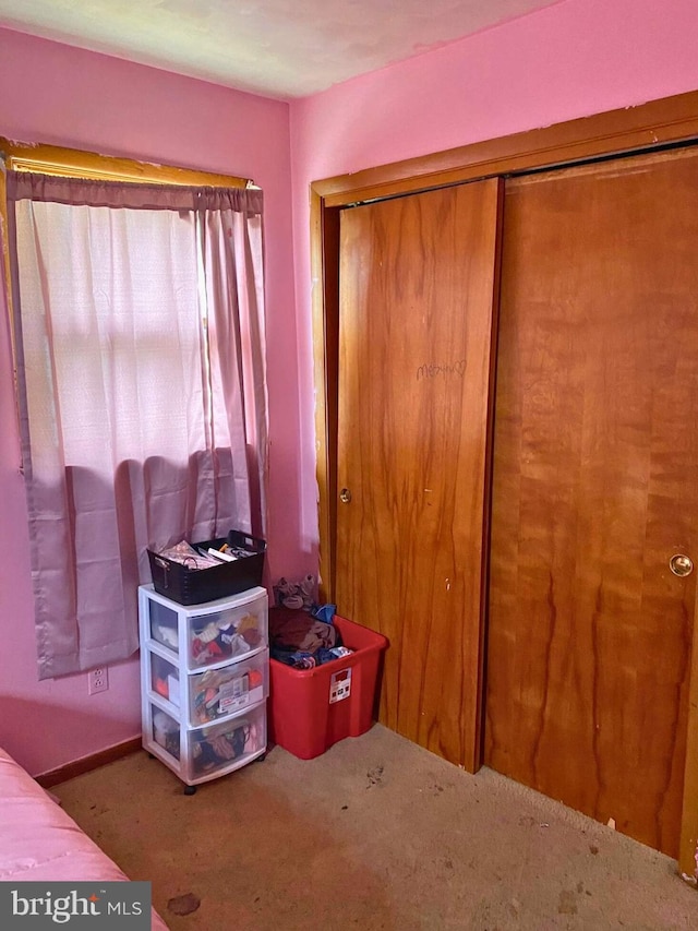 carpeted bedroom featuring a closet