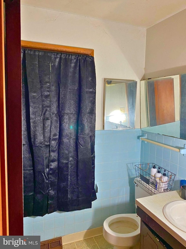 bathroom featuring tile walls, tile patterned flooring, vanity, and toilet