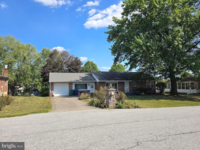 ranch-style house with a front yard and a garage