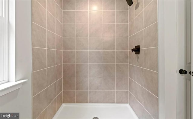 bathroom with tiled shower