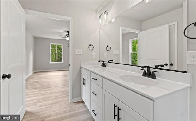 bathroom featuring vanity, hardwood / wood-style flooring, and ceiling fan