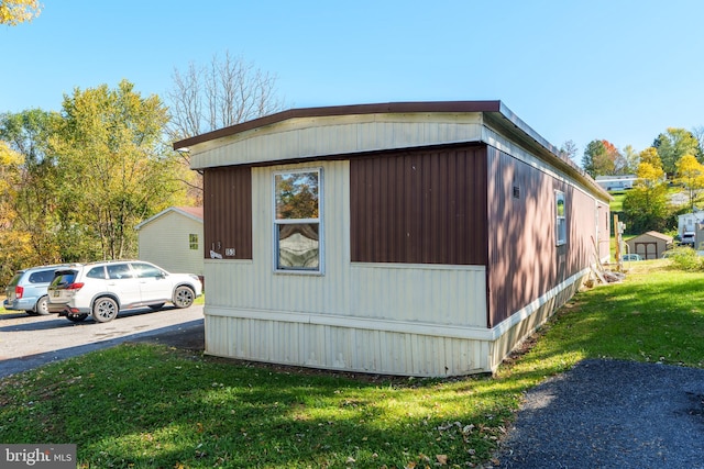 view of property exterior with a yard