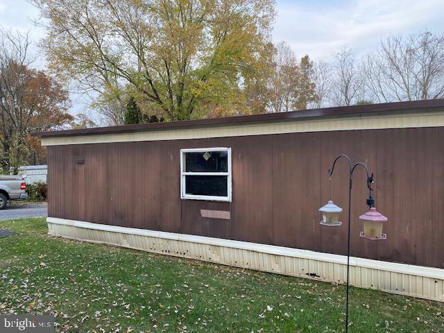 view of side of home with a yard