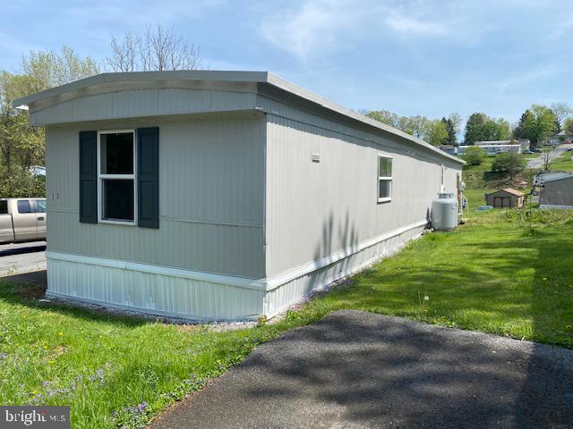 view of side of home with a yard
