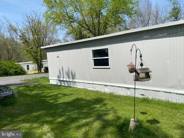 view of side of home with a yard