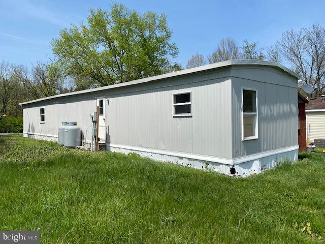 view of side of home with a yard