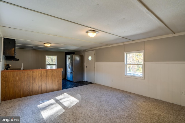 interior space featuring a wealth of natural light and wooden walls