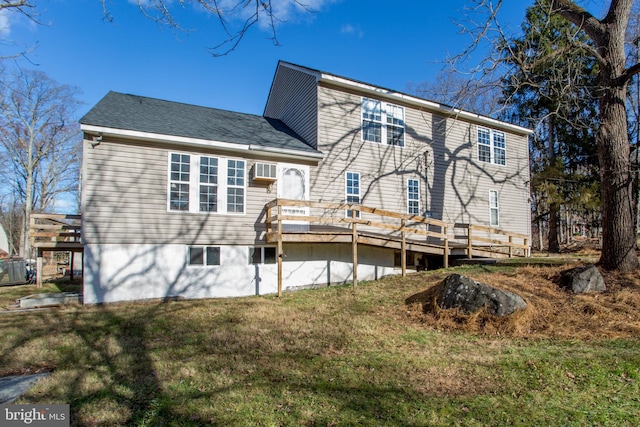 rear view of property with a yard and a wooden deck