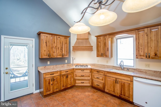 kitchen with vaulted ceiling, dishwasher, stainless steel gas cooktop, sink, and premium range hood