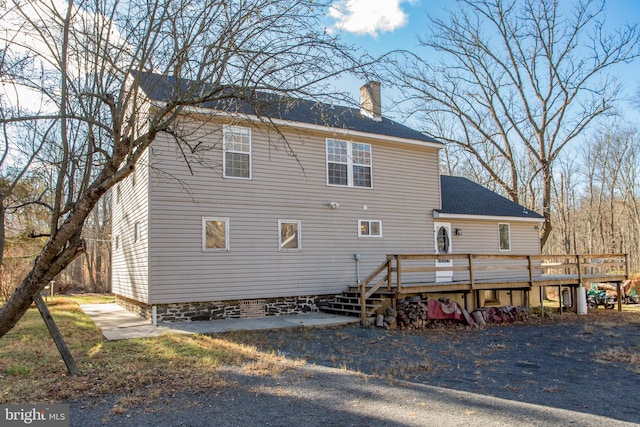 back of property featuring a deck