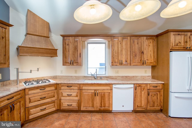 kitchen featuring light stone counters, sink, light tile patterned floors, custom range hood, and white appliances