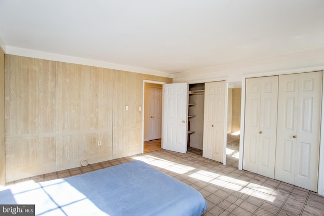 unfurnished bedroom with two closets